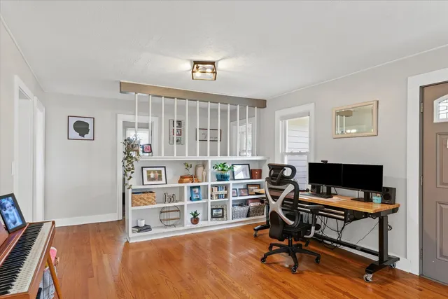 a view of a workspace with furniture and a window