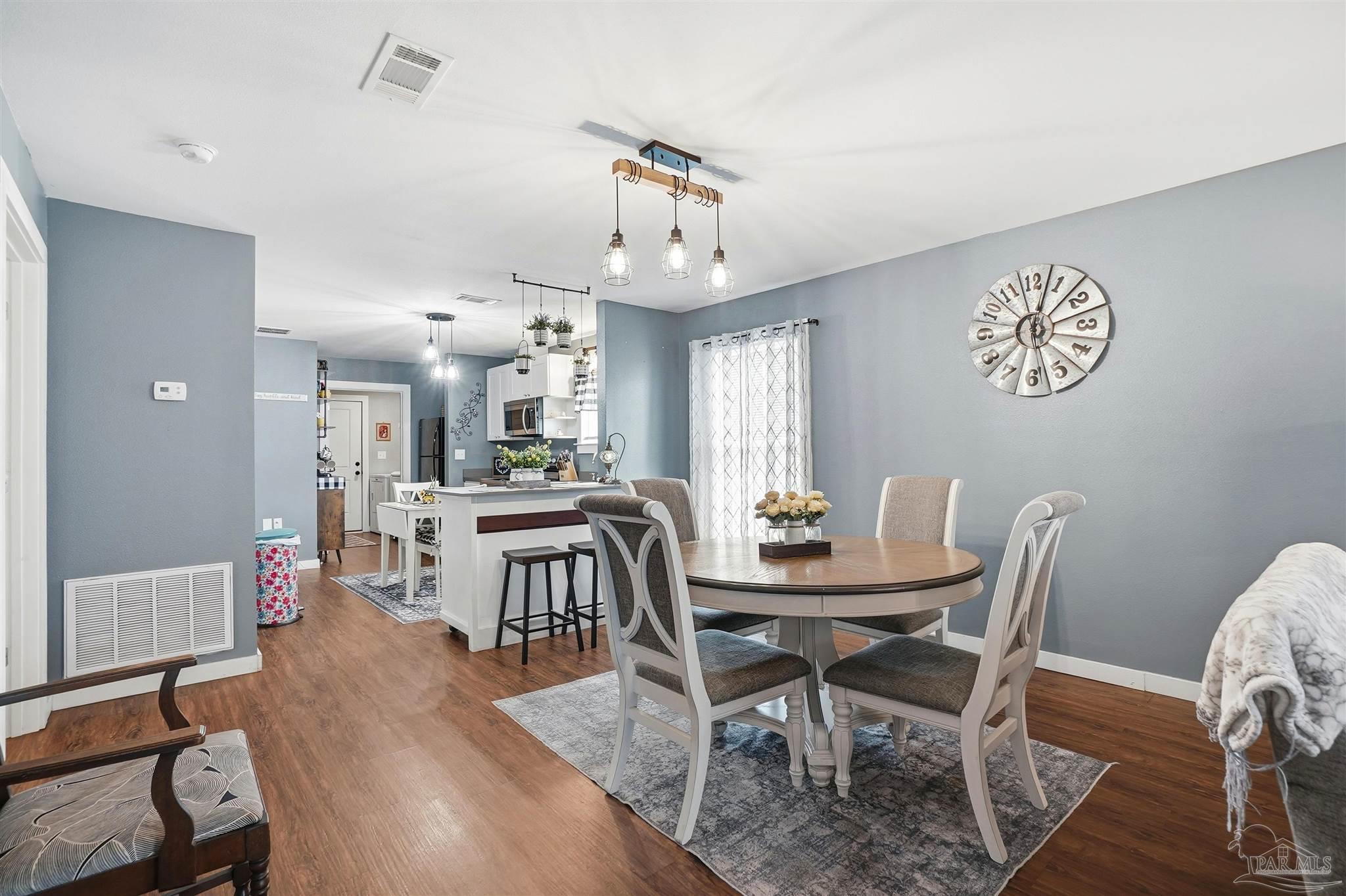 402 Front Street Century, FL 32535 - Photo 15 of 48 a view of a dining room with furniture and wooden floor