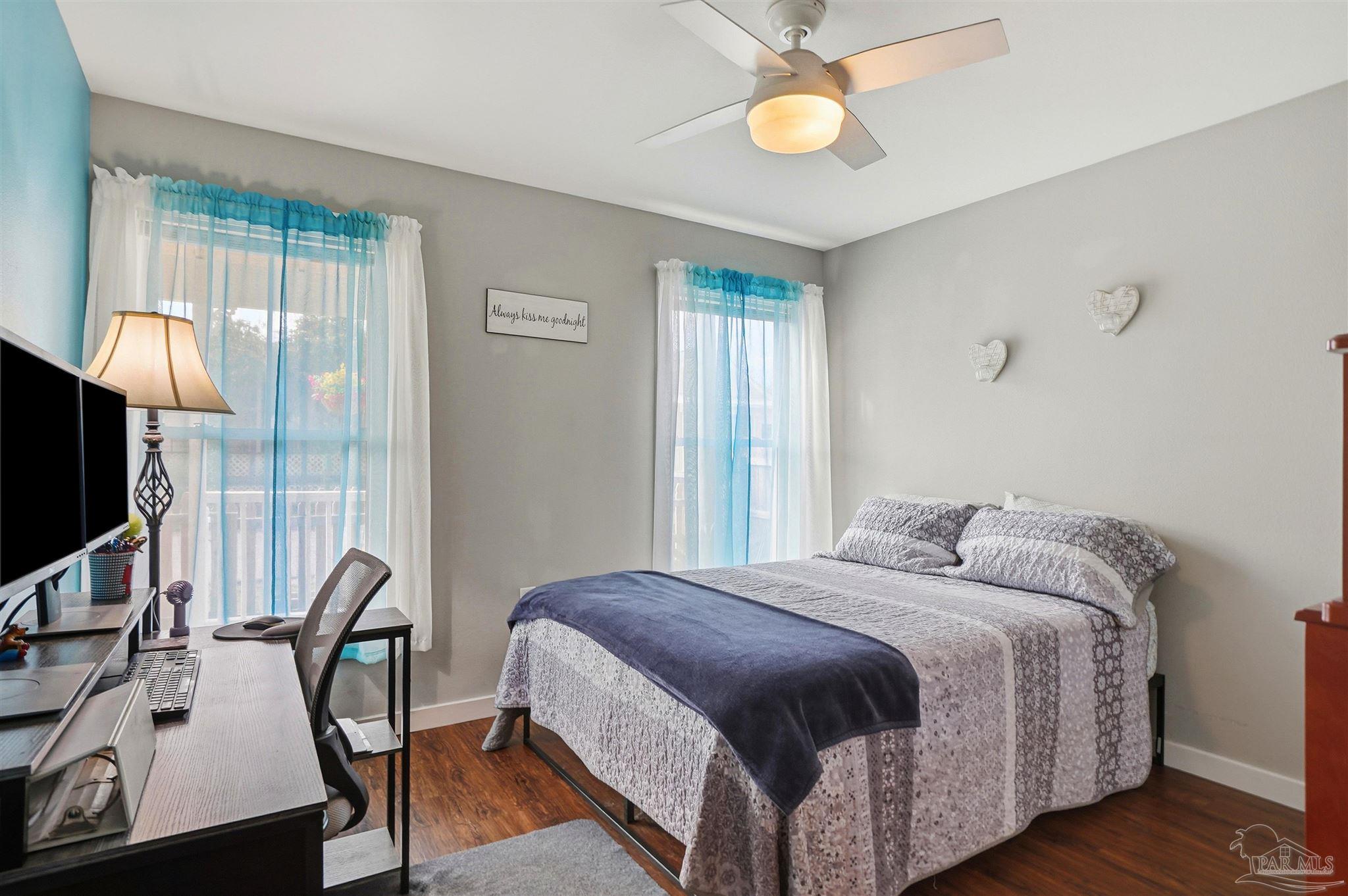 402 Front Street Century, FL 32535 - Photo 18 of 48 a bedroom with a bed a flat screen tv and a chandelier