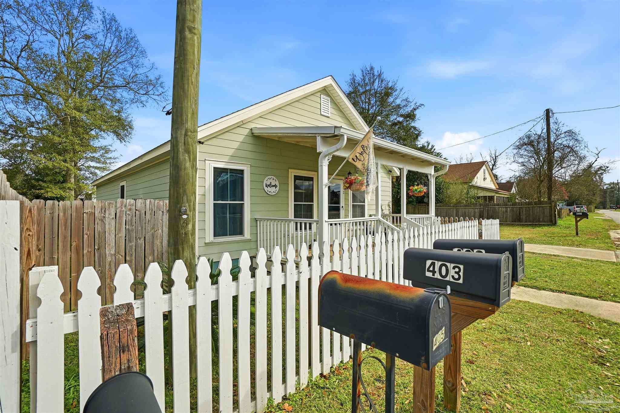 402 Front Street Century, FL 32535 - Photo 2 of 48 a front view of a house having yard
