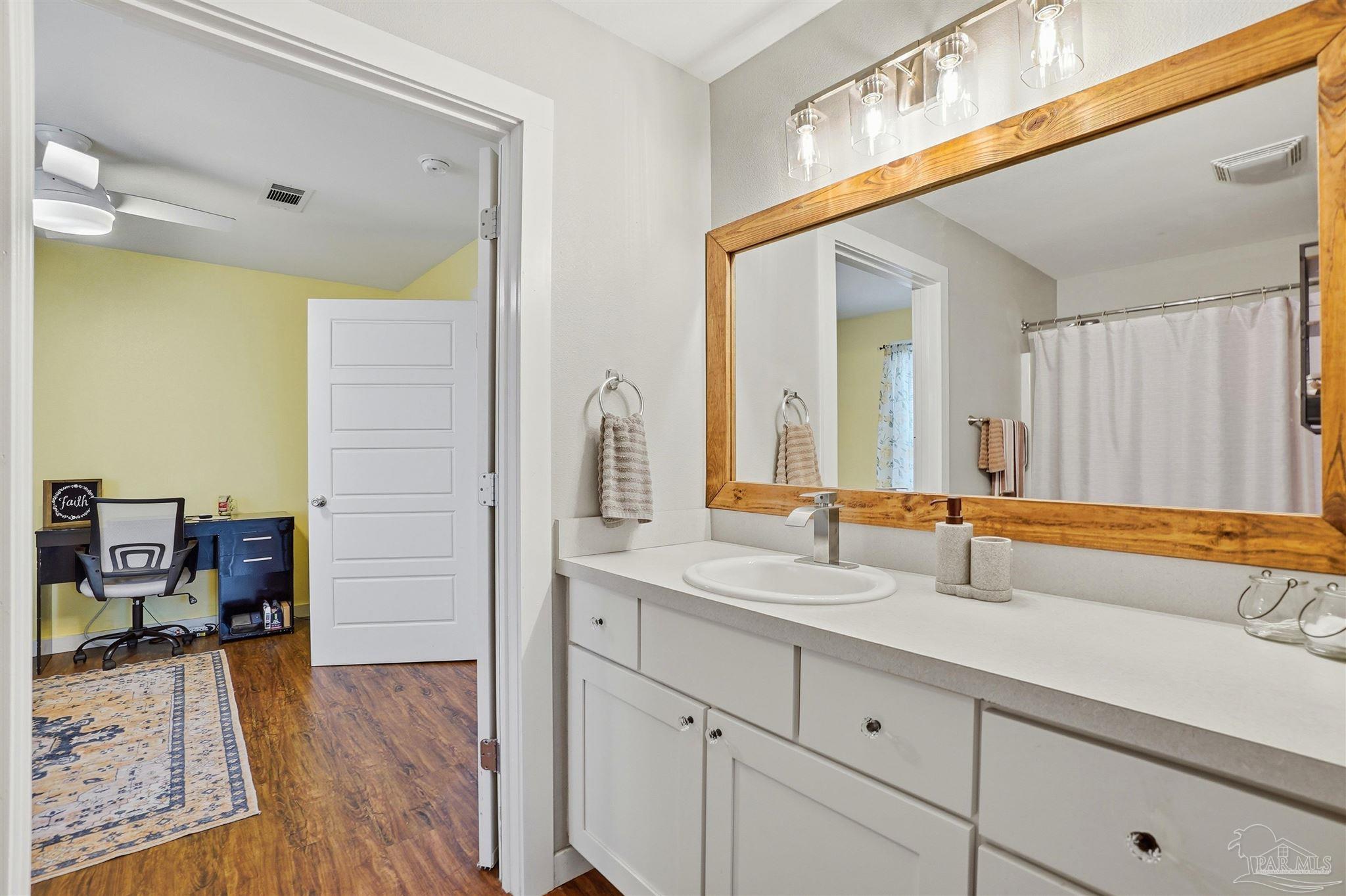402 Front Street Century, FL 32535 - Photo 23 of 48 a bathroom with a sink and a mirror