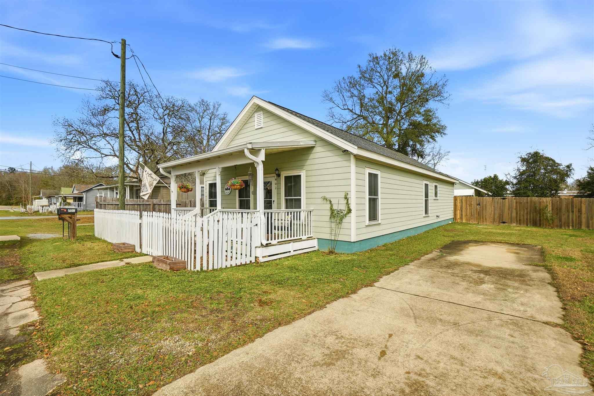 402 Front Street Century, FL 32535 - Photo 3 of 48 a view of a house with a yard