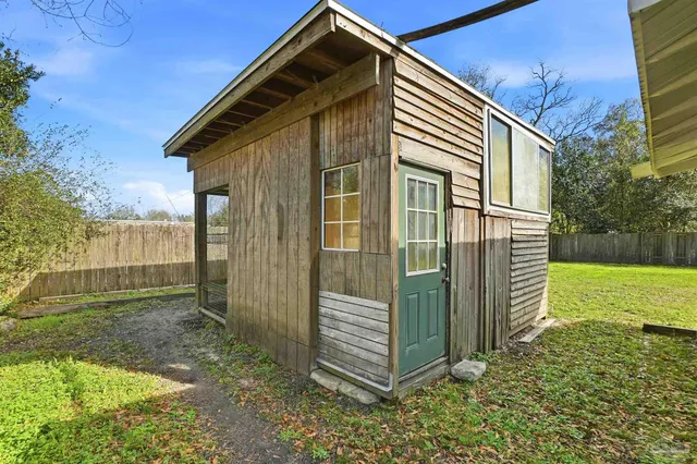 a backyard of a house with table and chairs