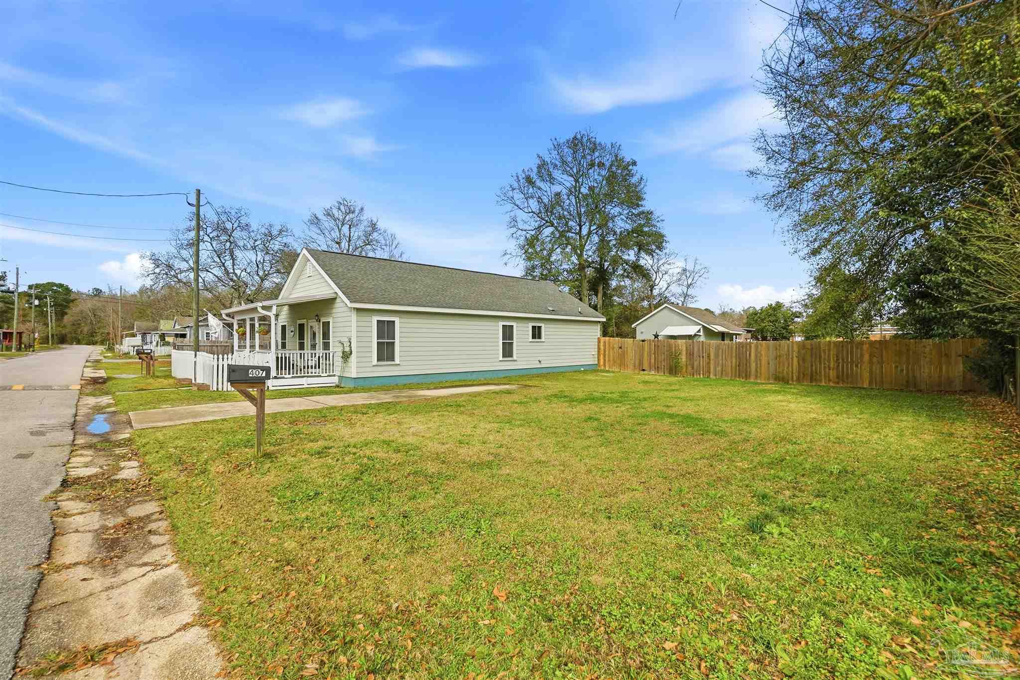 402 Front Street Century, FL 32535 - Photo 47 of 48 a front view of a house with a garden