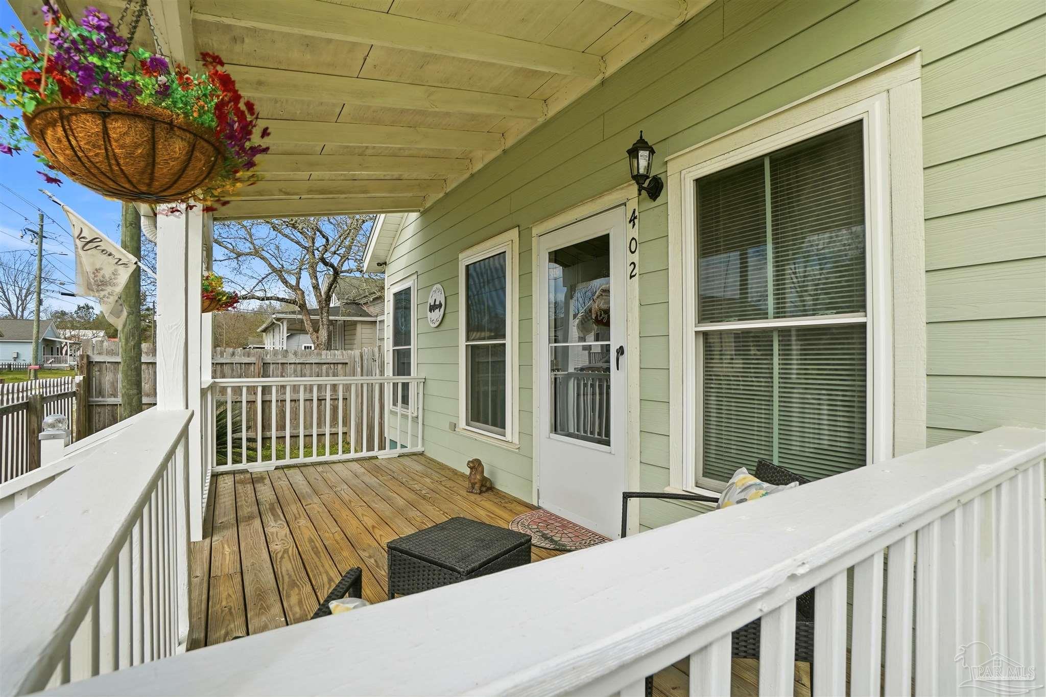 402 Front Street Century, FL 32535 - Photo 5 of 48 a view of a balcony with wooden floor and iron fence