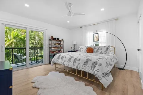 a spacious bedroom with a large bed and a chandelier