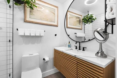 a bathroom with a sink a mirror and a toilet