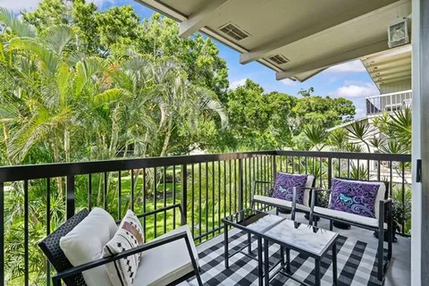 a view of a chairs and table in the balcony