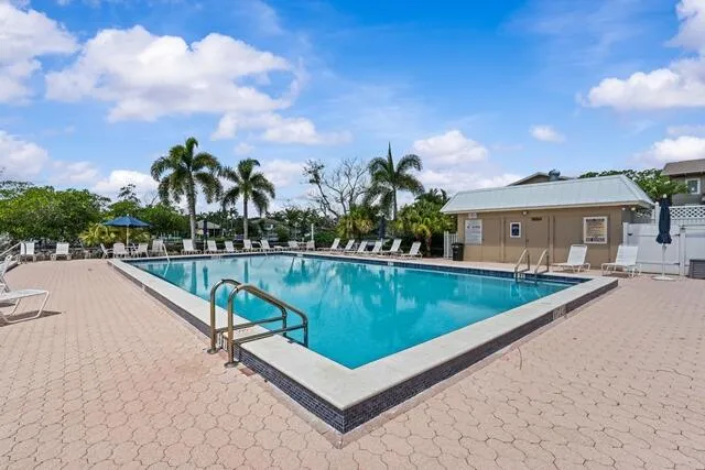 a view of swimming pool with a lounge chair