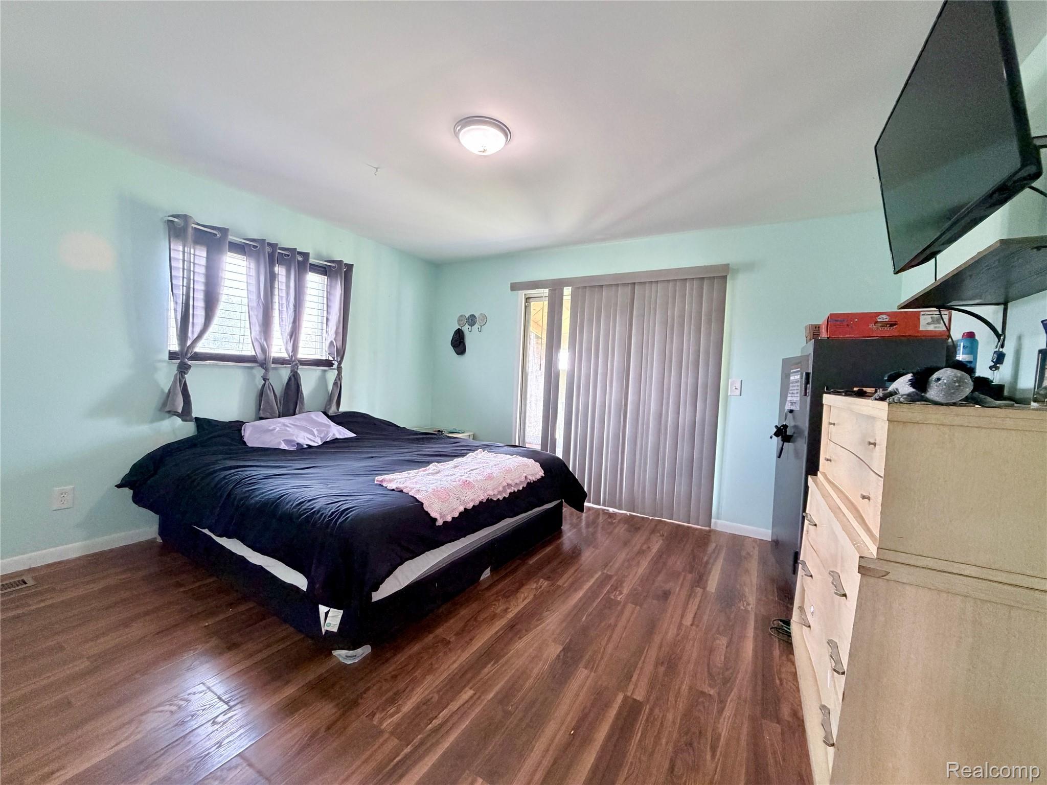 10865 Norman Road Yale, MI 48097 - Photo 11 of 23 Spacious interior featuring wood-finish flooring, a ceiling-mounted light fixture, and windows with horizontal blinds