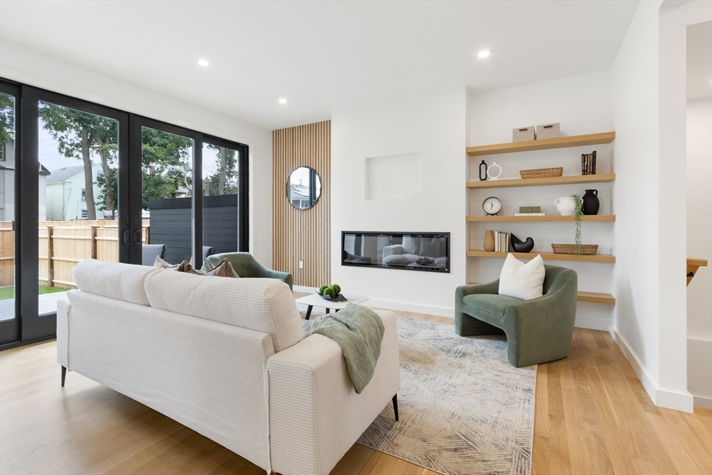 22 Appleton Street, Unit 1 Waltham, MA 02453 - Photo 14 of 36 a living room with furniture and a large window