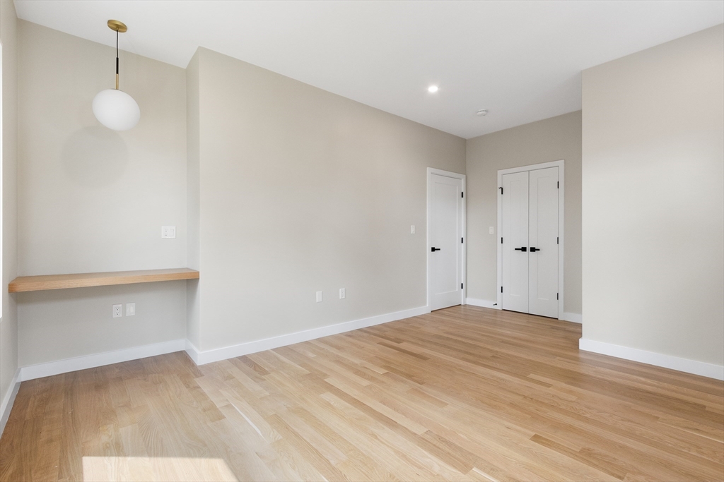 22 Appleton Street, Unit 1 Waltham, MA 02453 - Photo 21 of 36 a view of empty room with wooden floor