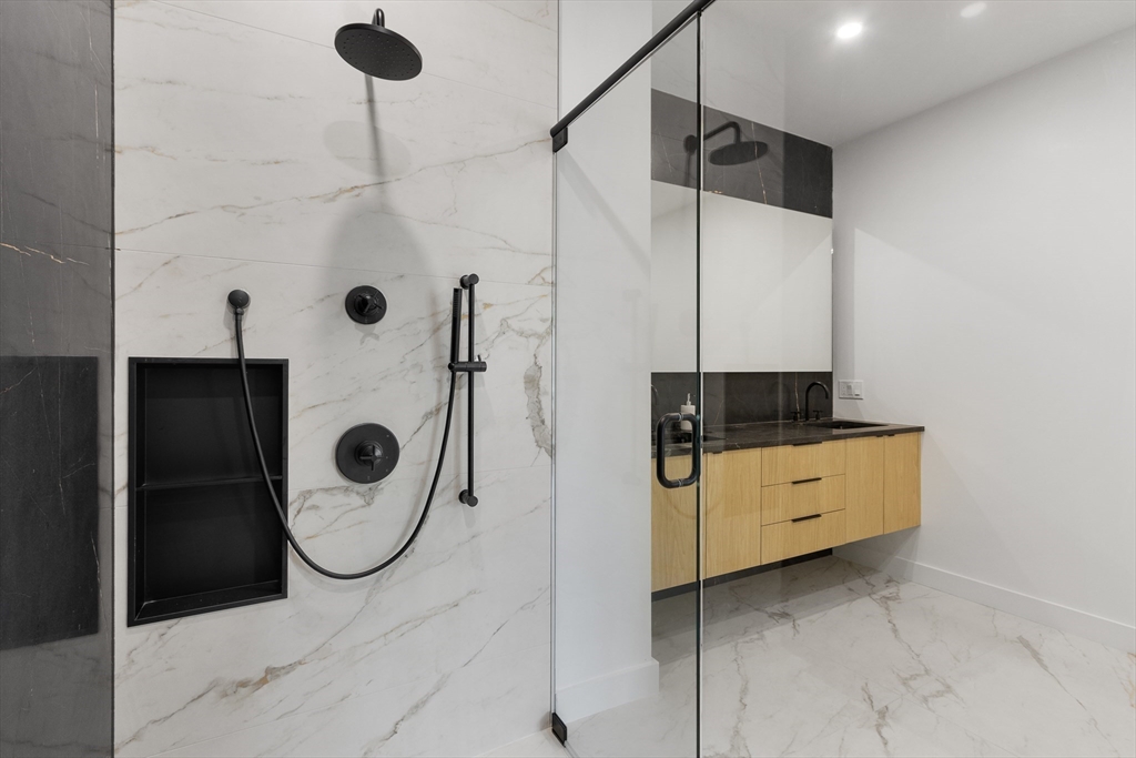 22 Appleton Street, Unit 1 Waltham, MA 02453 - Photo 22 of 36 a bathroom with a shower and mirror