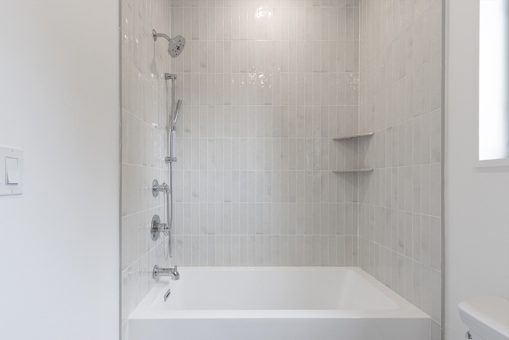 22 Appleton Street, Unit 1 Waltham, MA 02453 - Photo 28 of 36 a bathroom with a bathtub