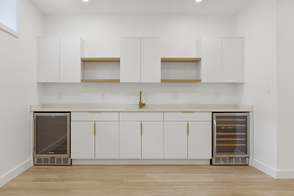 22 Appleton Street, Unit 1 Waltham, MA 02453 - Photo 30 of 36 a kitchen with stainless steel appliances cabinets and wooden floor