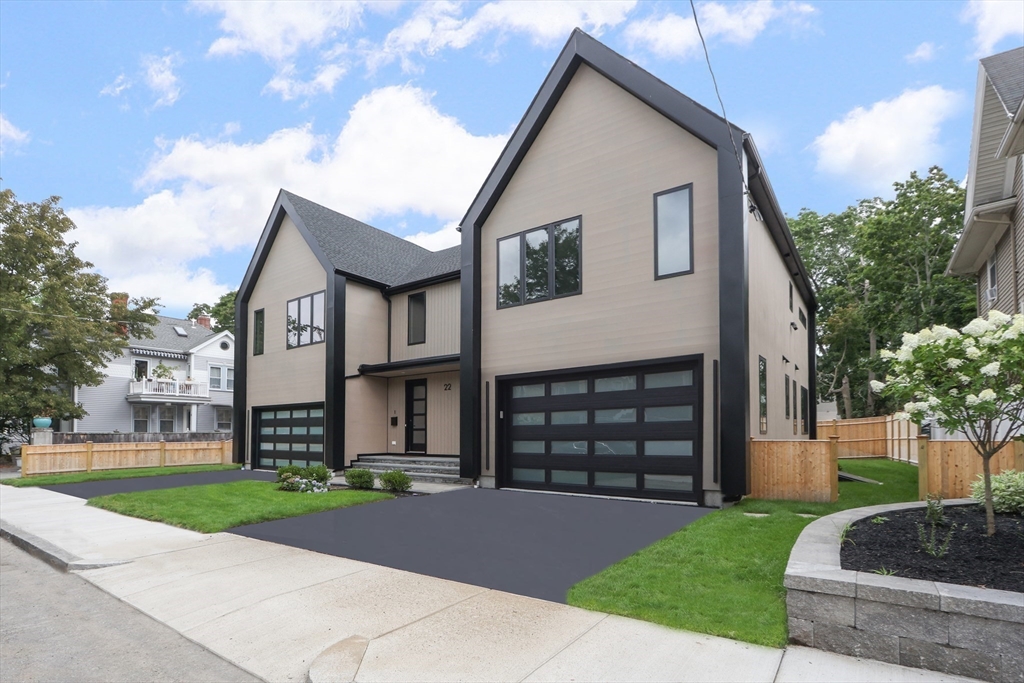 22 Appleton Street, Unit 1 Waltham, MA 02453 - Photo 3 of 36 a front view of a house with a garden and trees