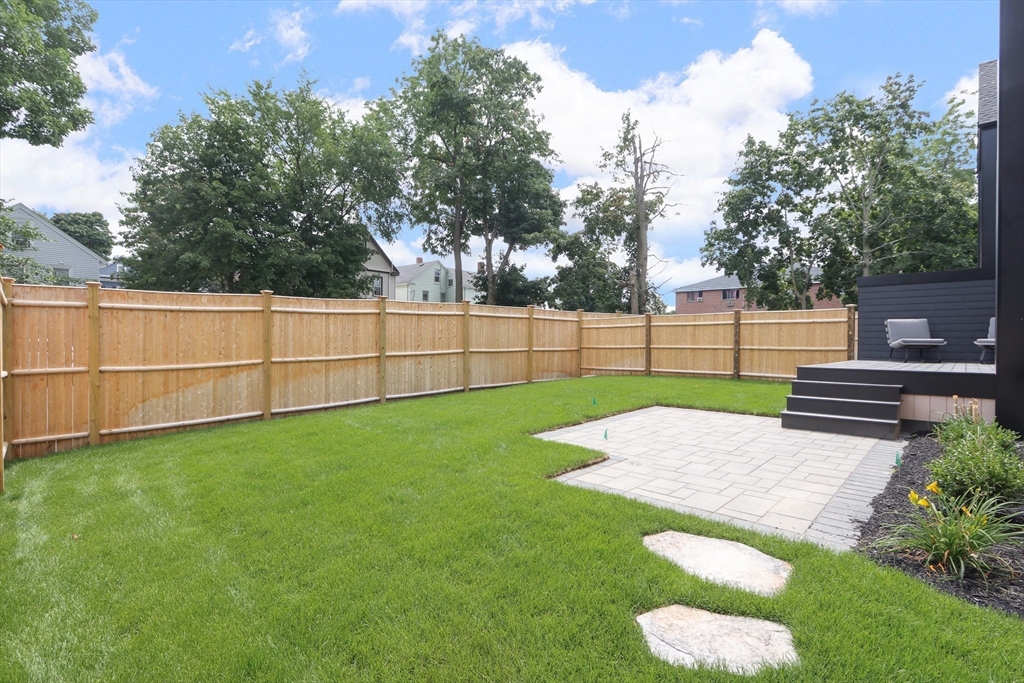 22 Appleton Street, Unit 1 Waltham, MA 02453 - Photo 33 of 36 a view of a backyard with wooden fence