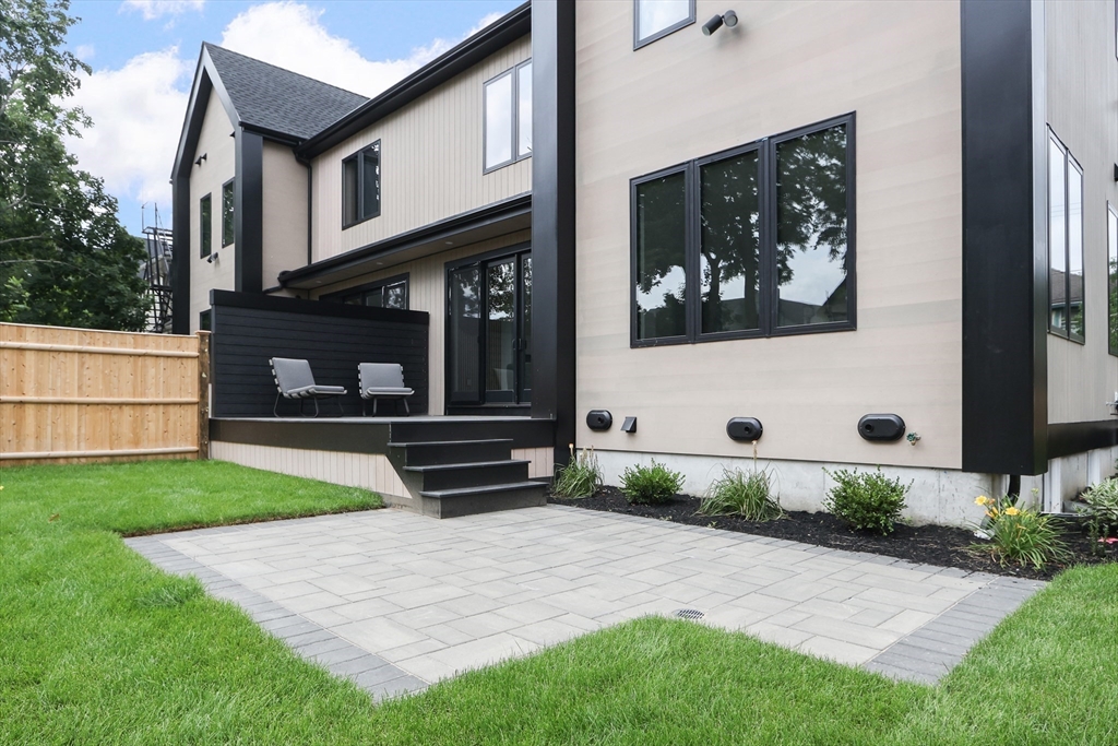 22 Appleton Street, Unit 1 Waltham, MA 02453 - Photo 34 of 36 a front view of a house with garden