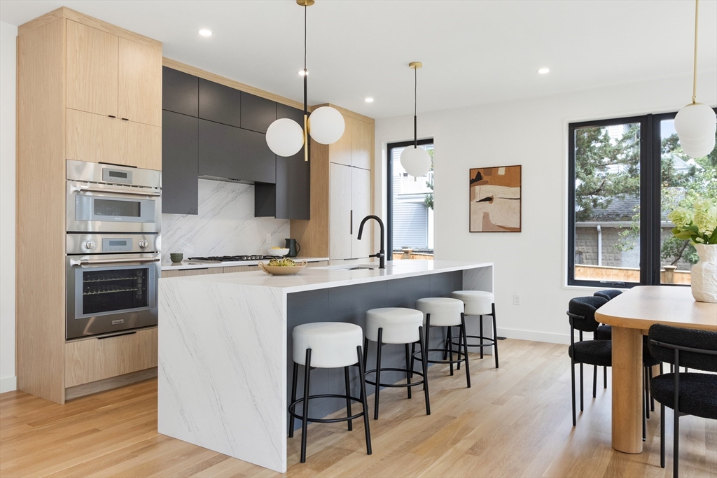 22 Appleton Street, Unit 1 Waltham, MA 02453 - Photo 6 of 36 a large kitchen with a table and chairs