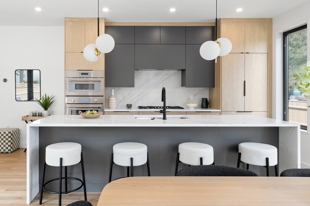 22 Appleton Street, Unit 1 Waltham, MA 02453 - Photo 8 of 36 a kitchen with a dining table and chairs