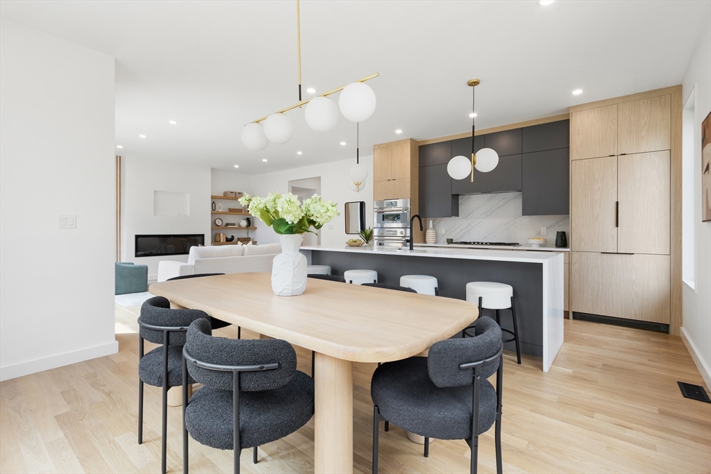 22 Appleton Street, Unit 1 Waltham, MA 02453 - Photo 10 of 36 a kitchen with a dining table chairs and wooden floor