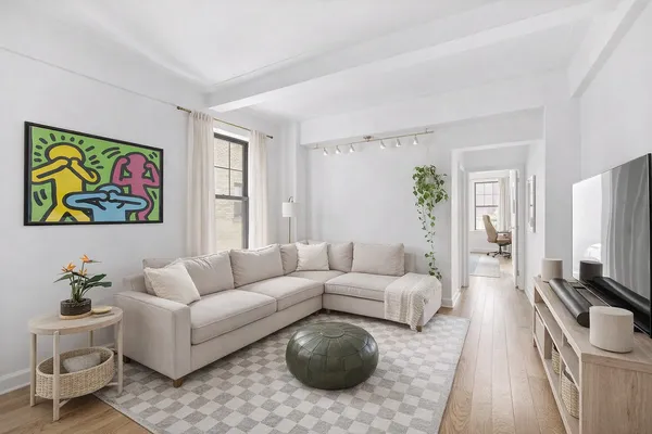 a living room with furniture a couch and a flat screen tv