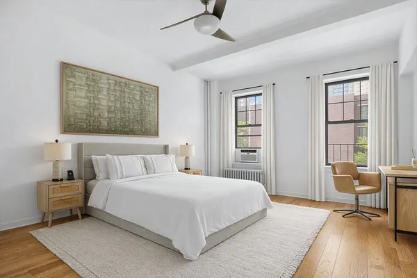 a bedroom with a bed a table and chair