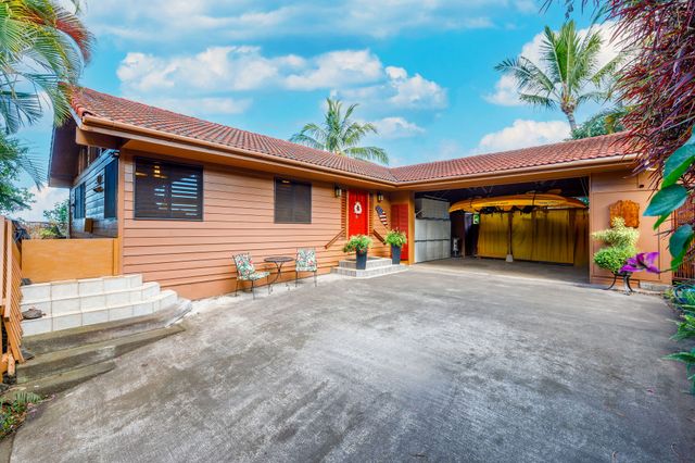 a view of a house with large space and a car parked area