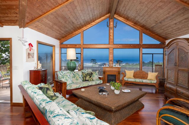 a living room with furniture a rug and a large window
