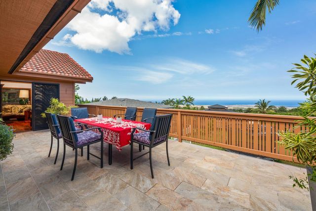 a view of a patio with a table and chairs