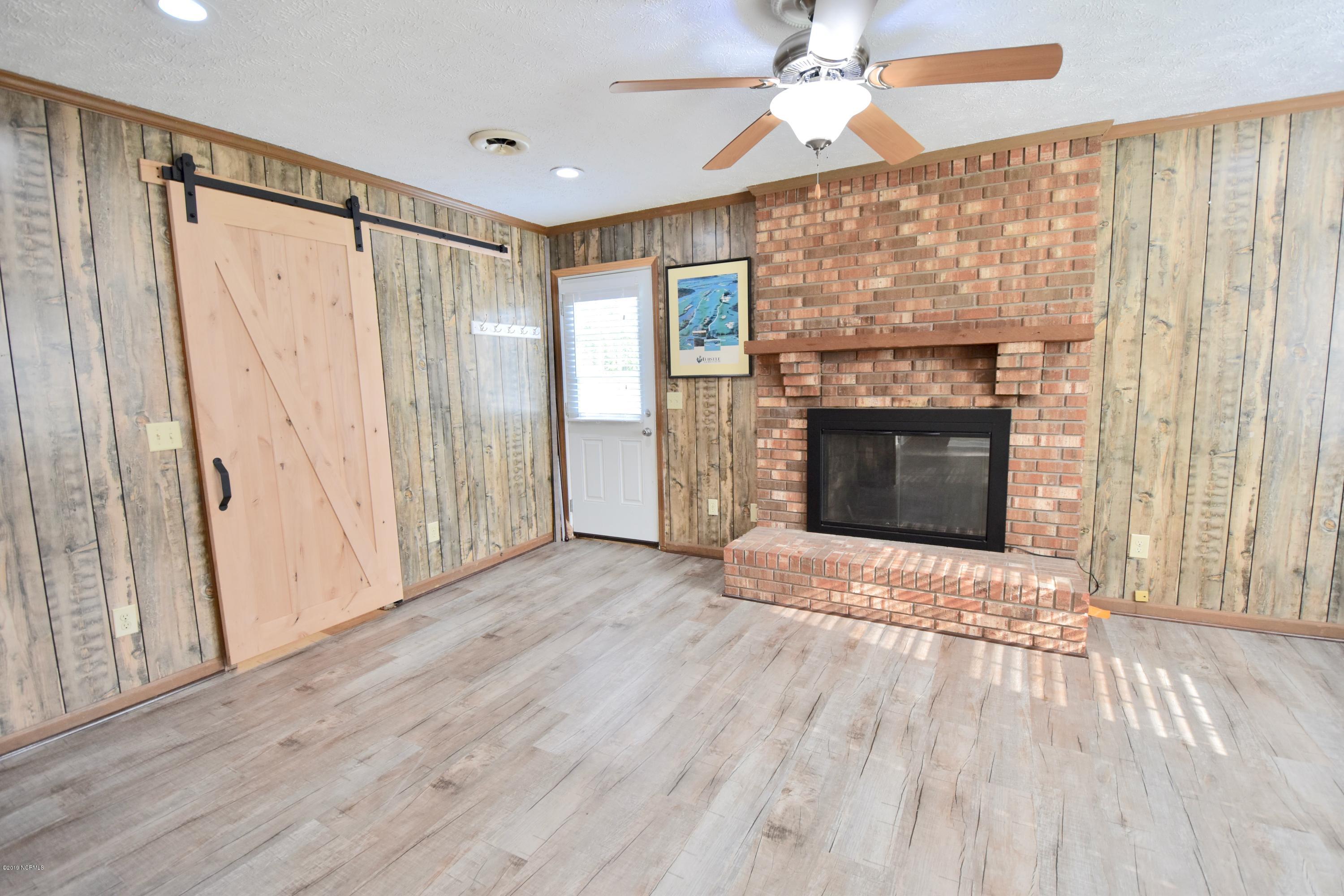 7 Logan Road Castle Hayne, NC 28429 - Photo 13 of 41 Family room...barn door leads to laundry/mudroom