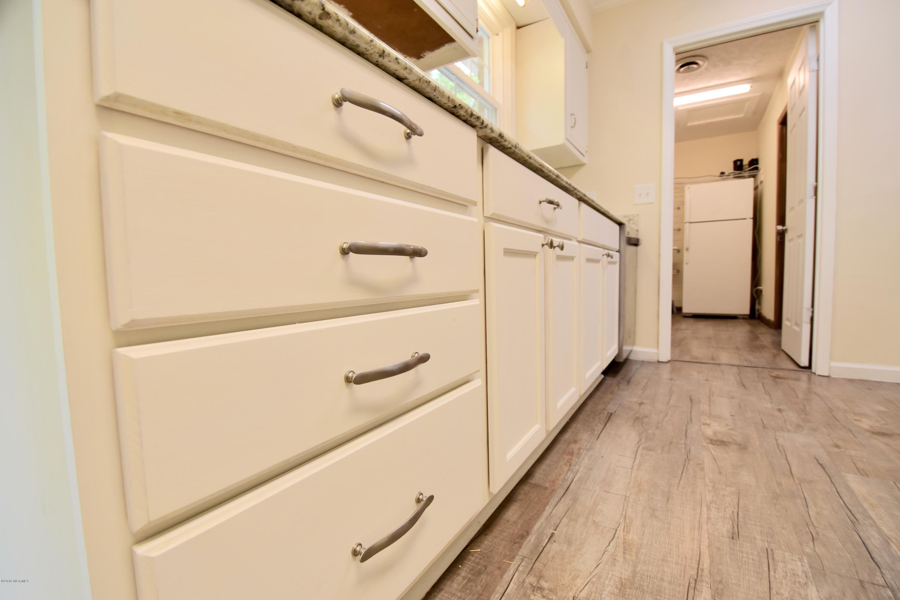 7 Logan Road Castle Hayne, NC 28429 - Photo 7 of 41 Beautiful luxury vinyl plank flooring. HUGE laundry room/pantry space off kitchen