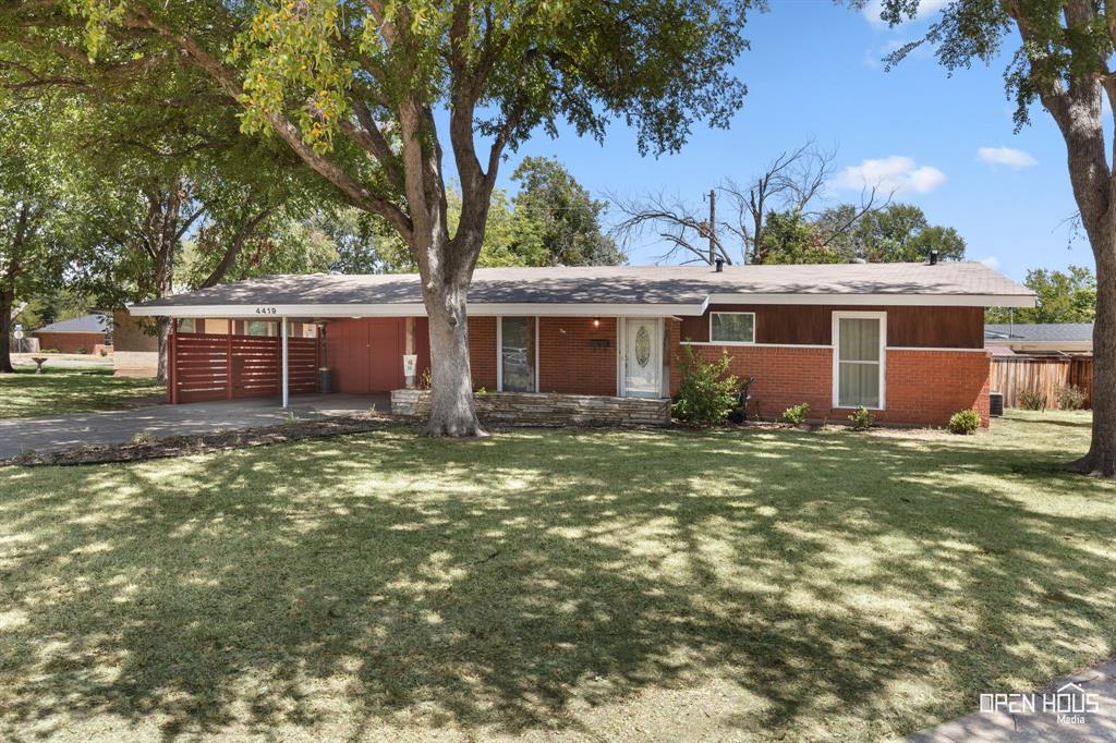 4419 Randel Drive Wichita Falls, TX 76308 - Photo 28 of 32 Brick exterior with wood paneling, a covered carport, and a stone-clad entry