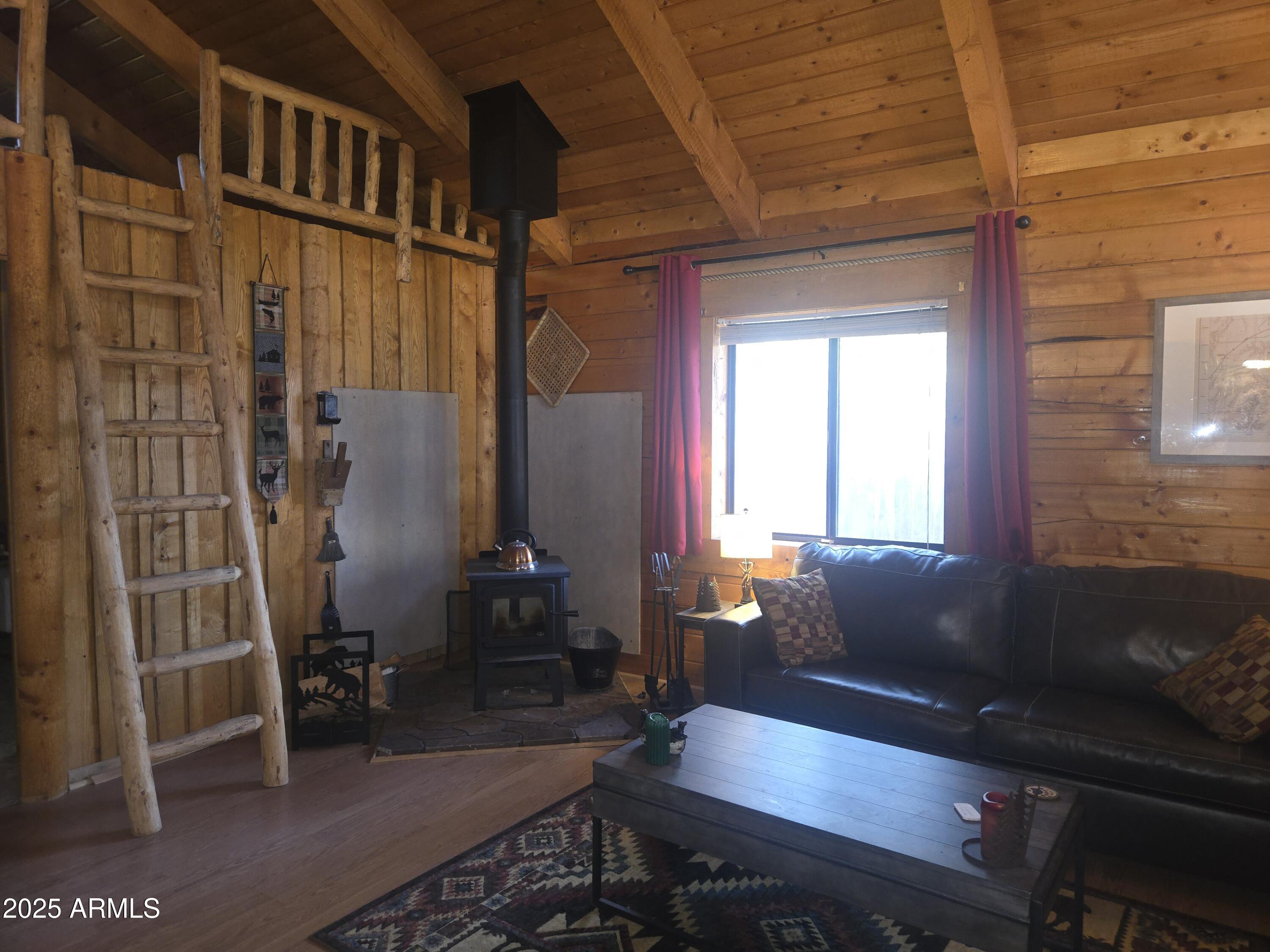 2145 Fishermans Road Overgaard, AZ 85933 - Photo 13 of 28 a living room with furniture a window and a table