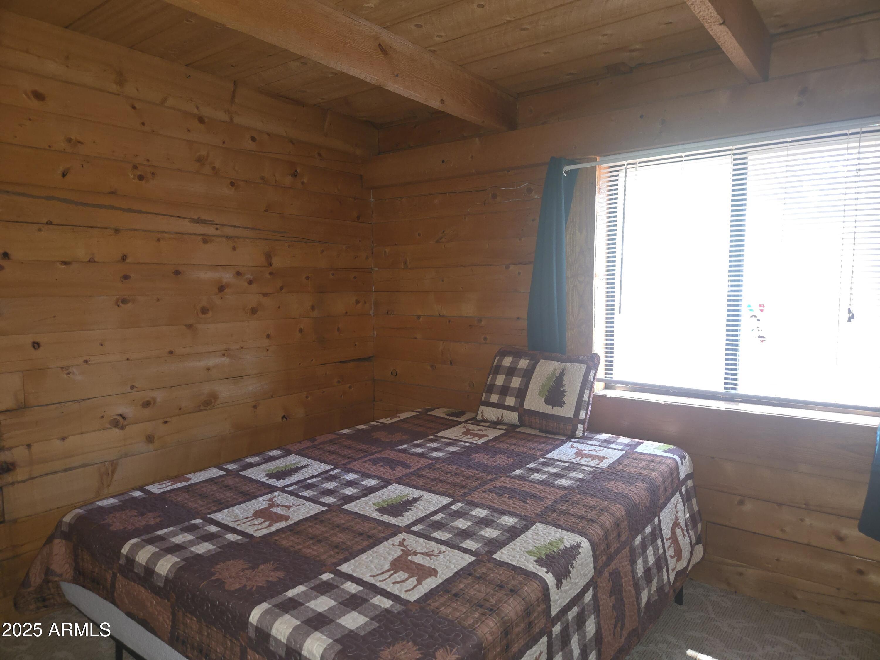 2145 Fishermans Road Overgaard, AZ 85933 - Photo 18 of 28 a bedroom with a bed and a window