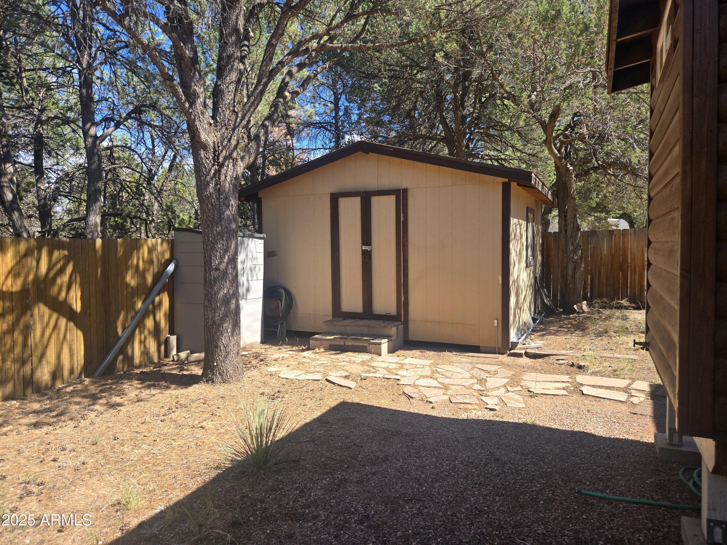2145 Fishermans Road Overgaard, AZ 85933 - Photo 24 of 28 a front view of a house with a yard