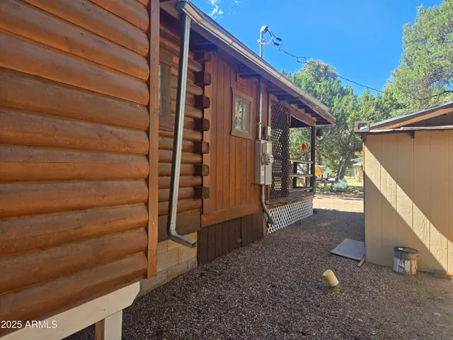 a view of a porch with wooden floor and furniture