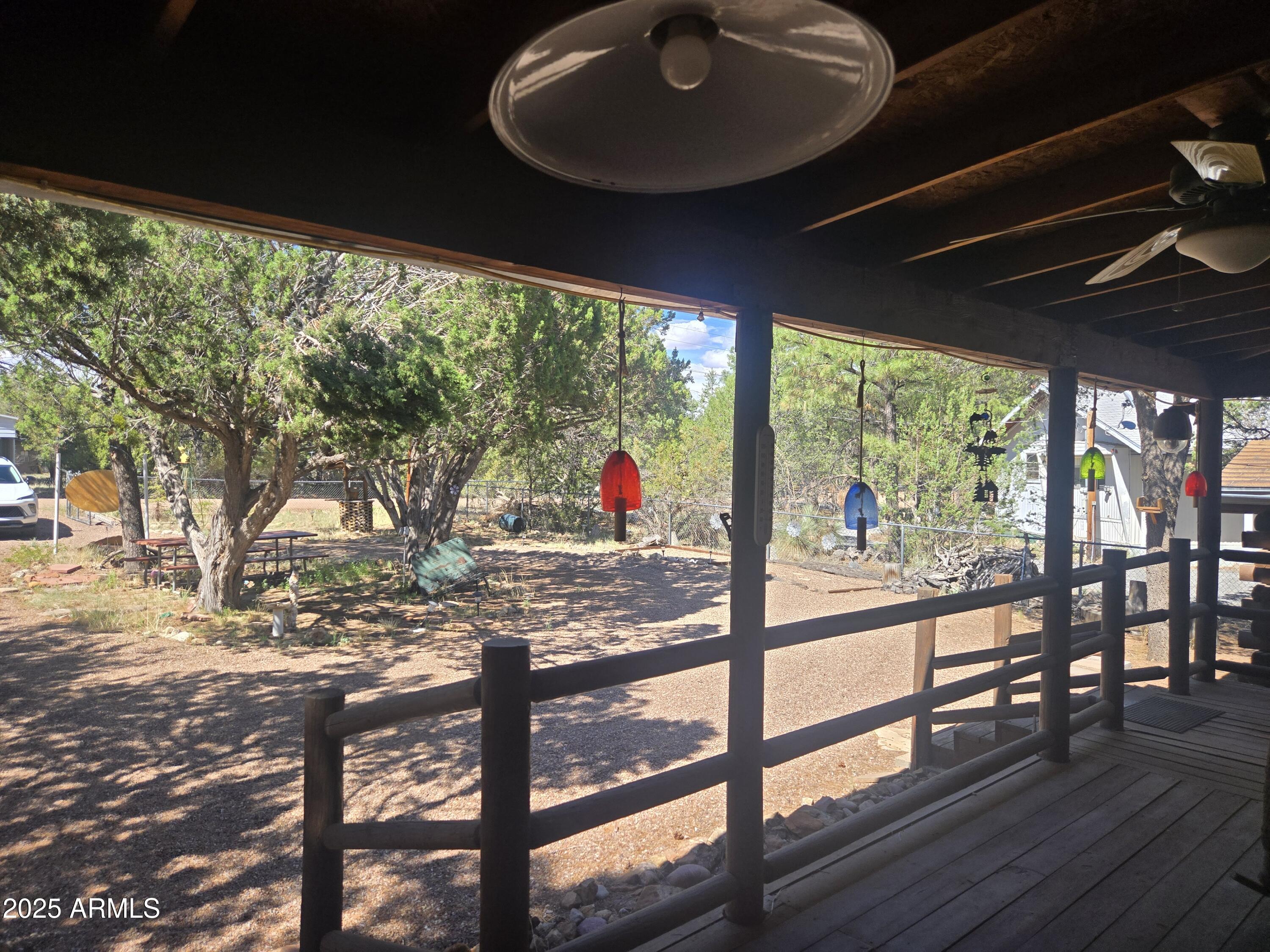 2145 Fishermans Road Overgaard, AZ 85933 - Photo 8 of 28 a view of a porch with wooden floor and furniture