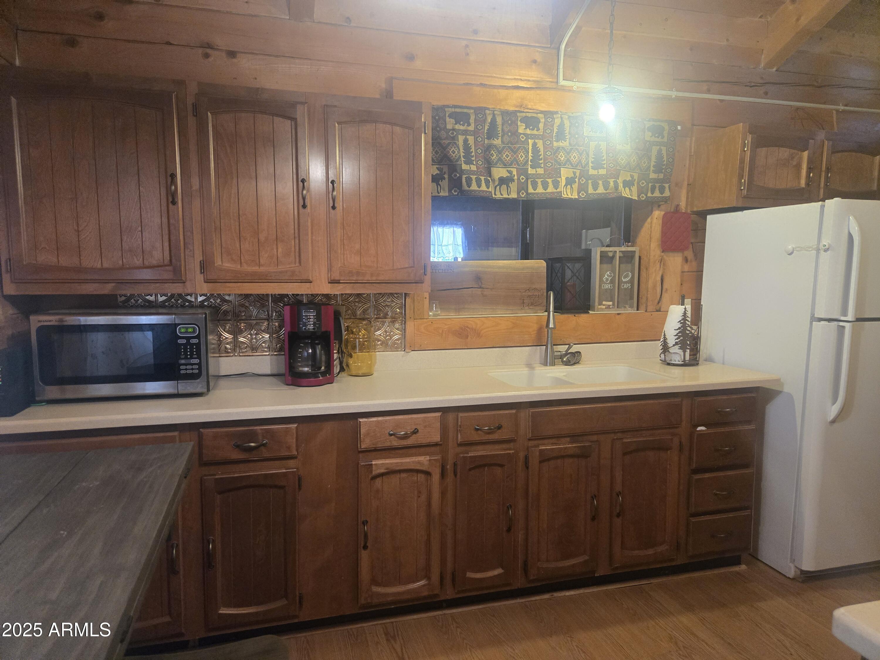 2145 Fishermans Road Overgaard, AZ 85933 - Photo 9 of 28 a kitchen with stainless steel appliances granite countertop a sink and a refrigerator
