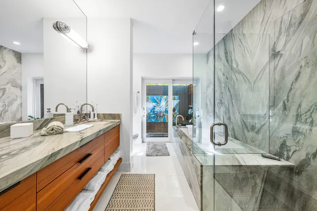 a en suite bathroom with a double vanity sink and a mirror