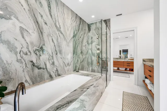 a spacious bathroom with a bathtub and a shower