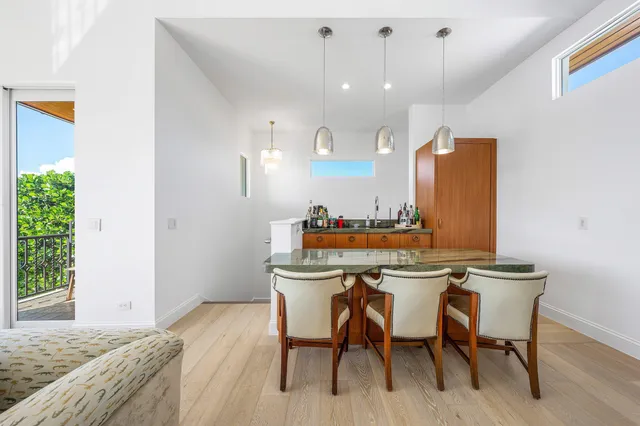 a bedroom with a bed and a flat tv screen on the dresser