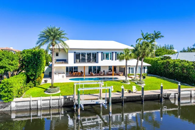 an aerial view of a houses with outdoor space and lake view