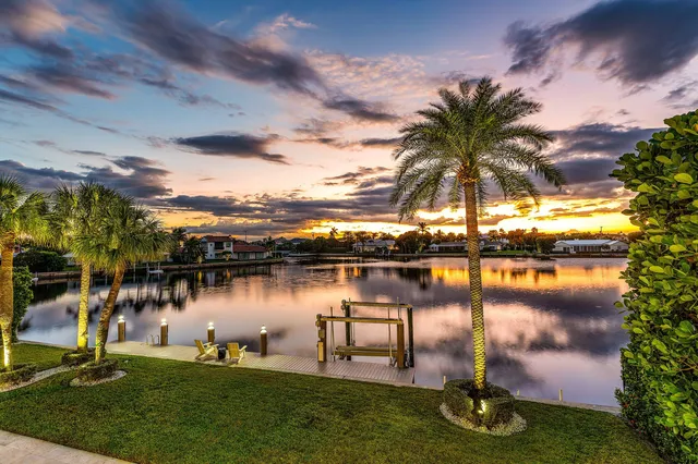 a view of a lake with a table and chairs