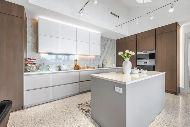 a kitchen with kitchen island a sink stainless steel appliances and cabinets