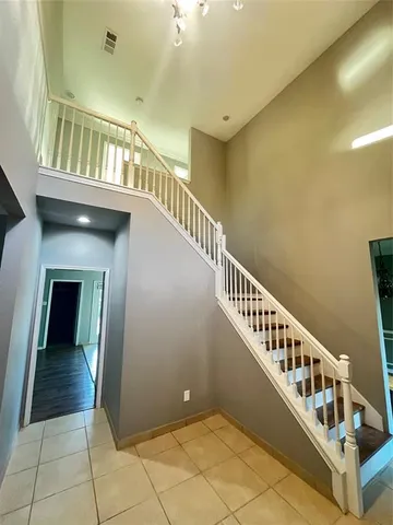 a view of entryway and hall with wooden floor