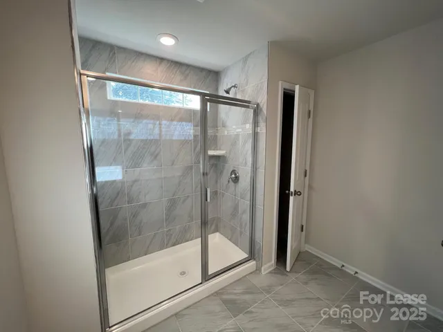 a bathroom with a glass shower door