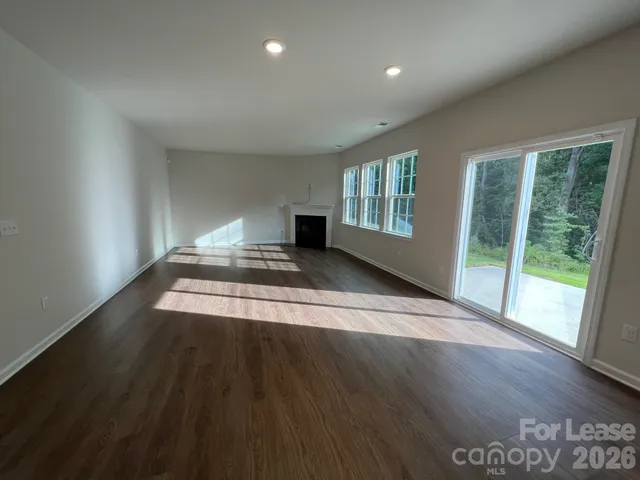 a kitchen with a refrigerator a stove top oven and a large window