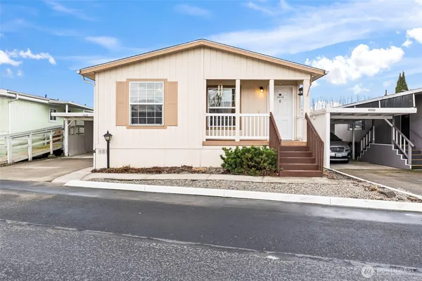 a front view of a house with a road