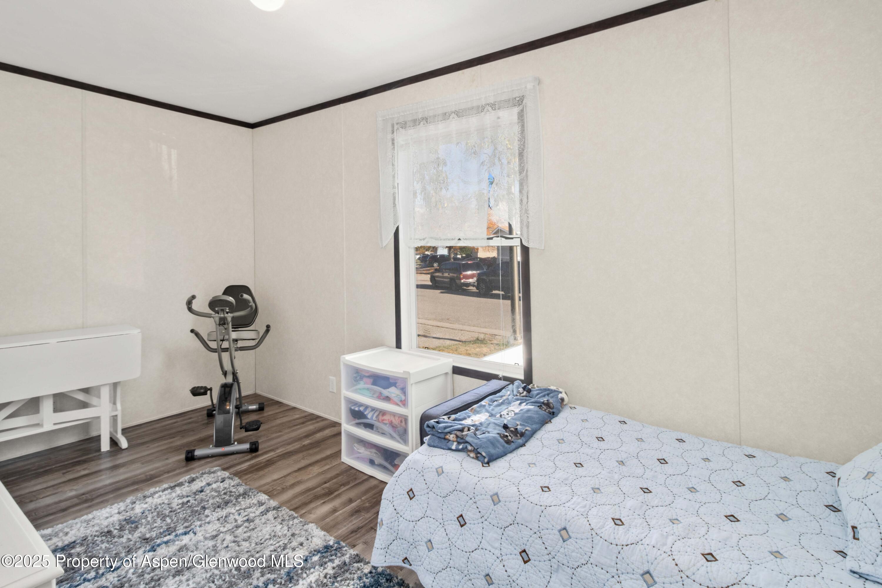 116 Iron Wedge Circle Parachute, CO 81635 - Photo 11 of 20 a bedroom with a bed and a chandelier